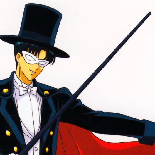 Tuxedo Mask in top hat, mask and cape, smiling, holding his black cane out at an angle