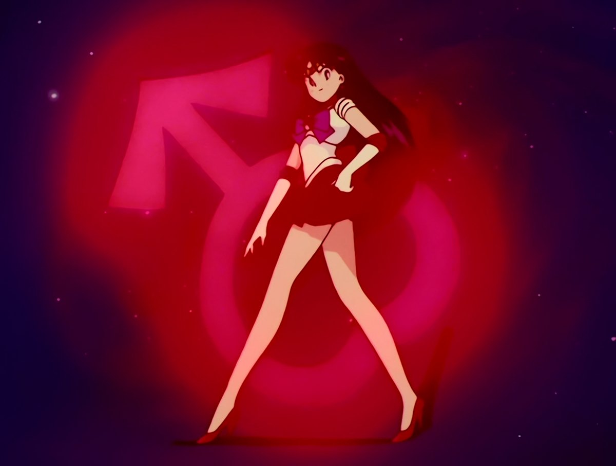 Sailor Mars landing the final pose of her transformation, the Mars glyph burning behind her.