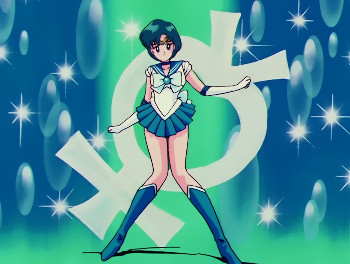 Sailor Mercury landing the final pose of her transformation, arms out, the Mercury glyph behind her.