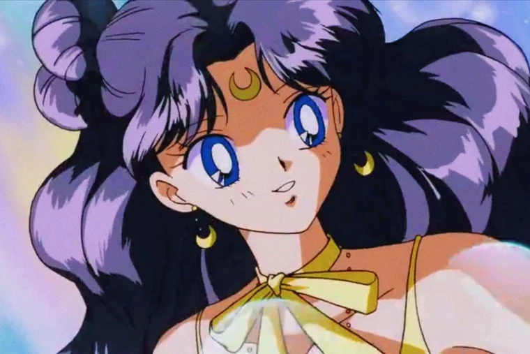 Luna in human form, smiling, with long dark hair, a gold crescent on her forehead and crescent earrings