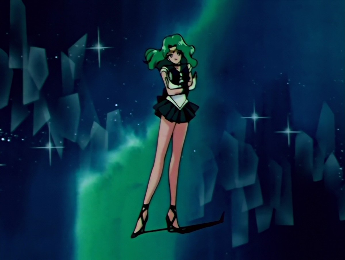 Sailor Neptune at the end of her transformation, arms folded and head tilted, standing in a starry blue-green sky among pale crystal shards.