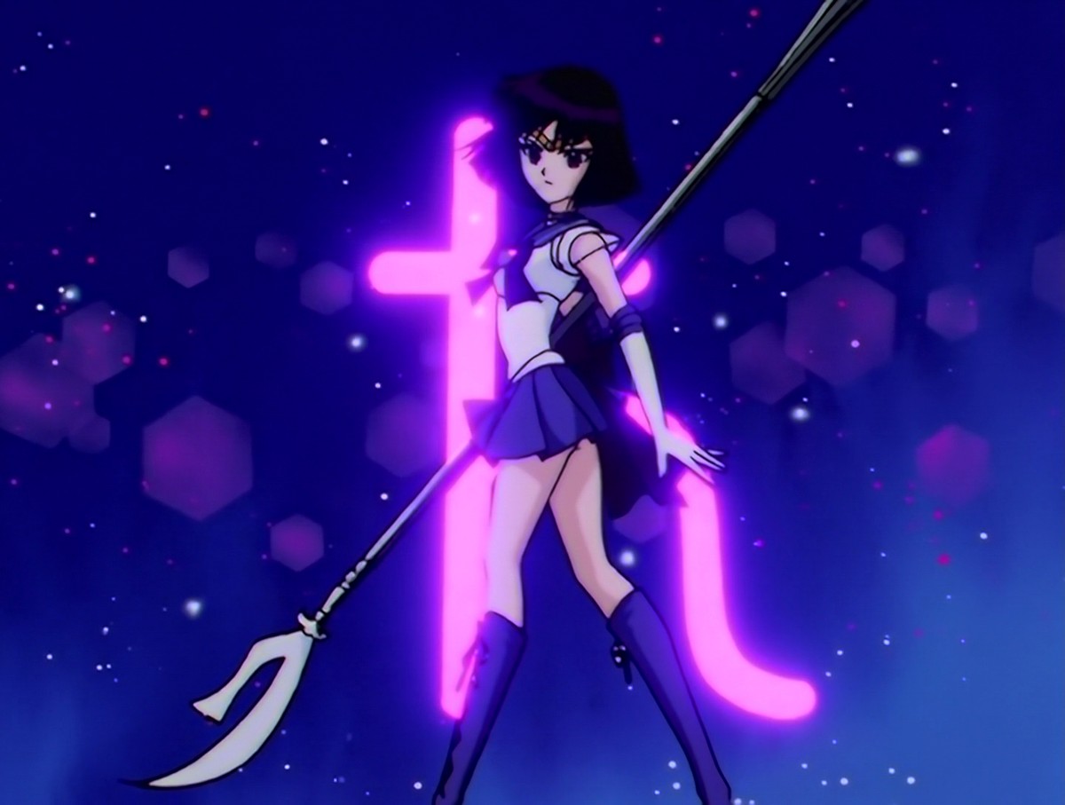 Sailor Saturn landing the final pose of her transformation, the Saturn glyph burning behind her.