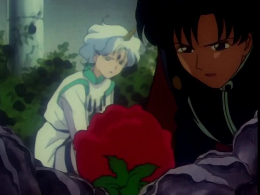 Prince Endymion, caped, beside a large red rose among dark stones, with Helios in white robes behind him