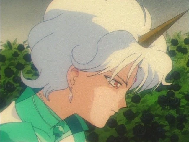 Helios from the 90s anime in profile: white hair, a golden horn and a crystal earring, against a hedge of black roses