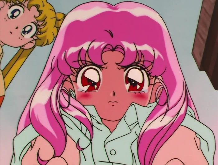 Chibiusa&rsquo;s face filling the frame, her eyes brimming and her cheeks flushed, with Usagi leaning upside-down into the corner behind her
