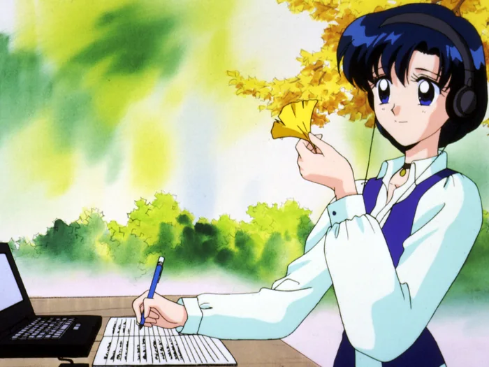 Ami outdoors under a ginkgo tree, headphones on, writing with one hand and turning a yellow leaf in the other