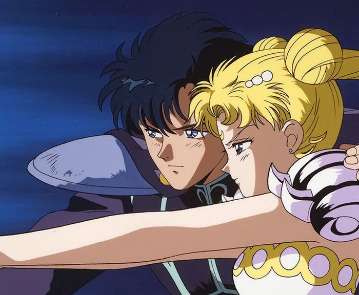 Princess Serenity and Prince Endymion cheek to cheek against a dark blue sky, her arm held out in front of them both