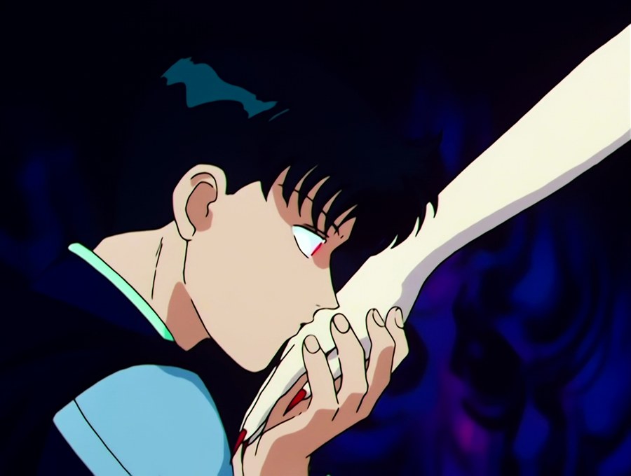 Tuxedo Mask fallen, a gloved hand at his face