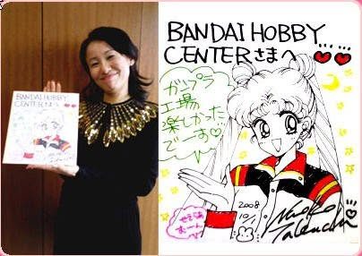 Naoko Takeuchi at the Bandai Hobby Centre holding a card she drew for them