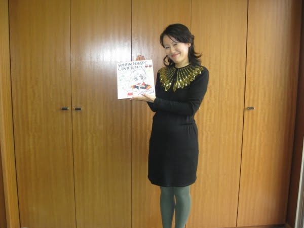 Naoko Takeuchi holding up a book, recently