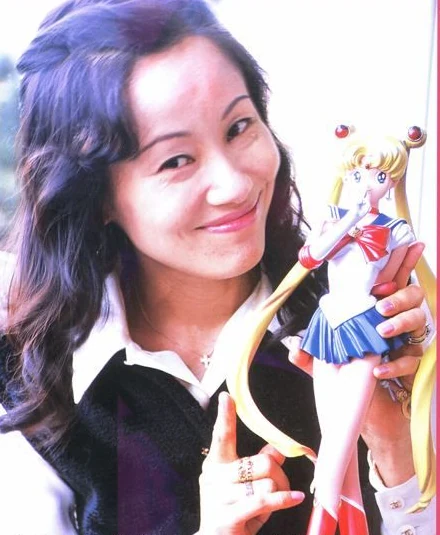 Naoko Takeuchi holding a Sailor Moon figure, photographed for a Nakayoshi-era interview