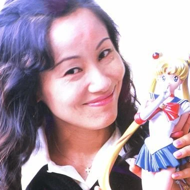 Naoko Takeuchi holding a Sailor Moon figure