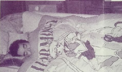 Togashi asleep under a Sailor Moon quilt