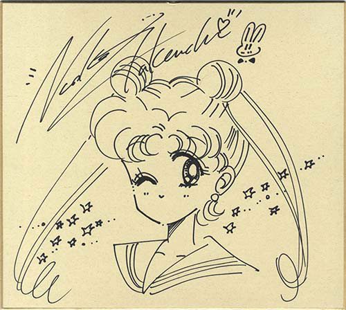 A signed board with a drawing of Usagi on it