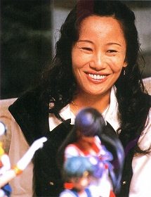 Naoko Takeuchi smiling, holding a figure