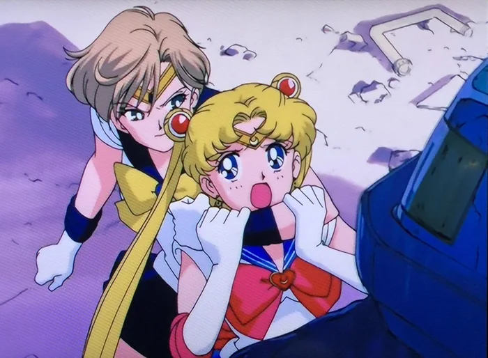Sailor Uranus looking back with a smirk, Sailor Moon held behind her with both hands at her mouth