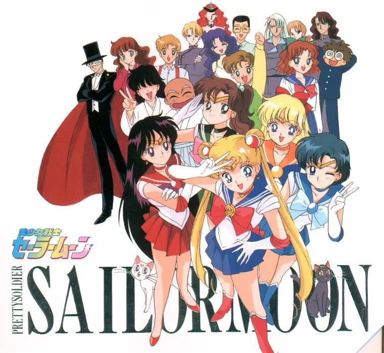 The Sailor Moon season one cast, with Tuxedo Mask, the four guardians, Luna, Artemis and the Juban regulars behind them